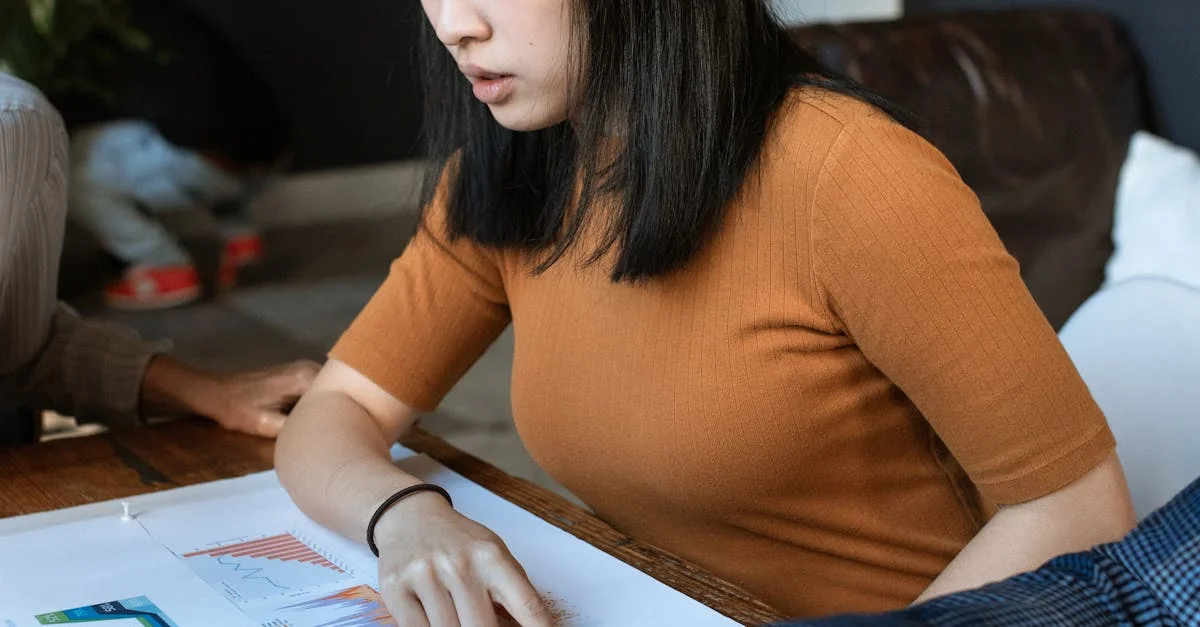 Young woman engaged in work at a creative office space with design documents.