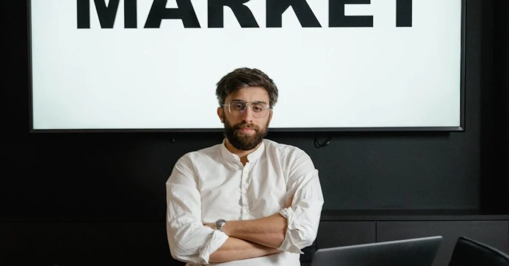 Professional businessman with arms crossed in front of a stock market display in a modern office setting.