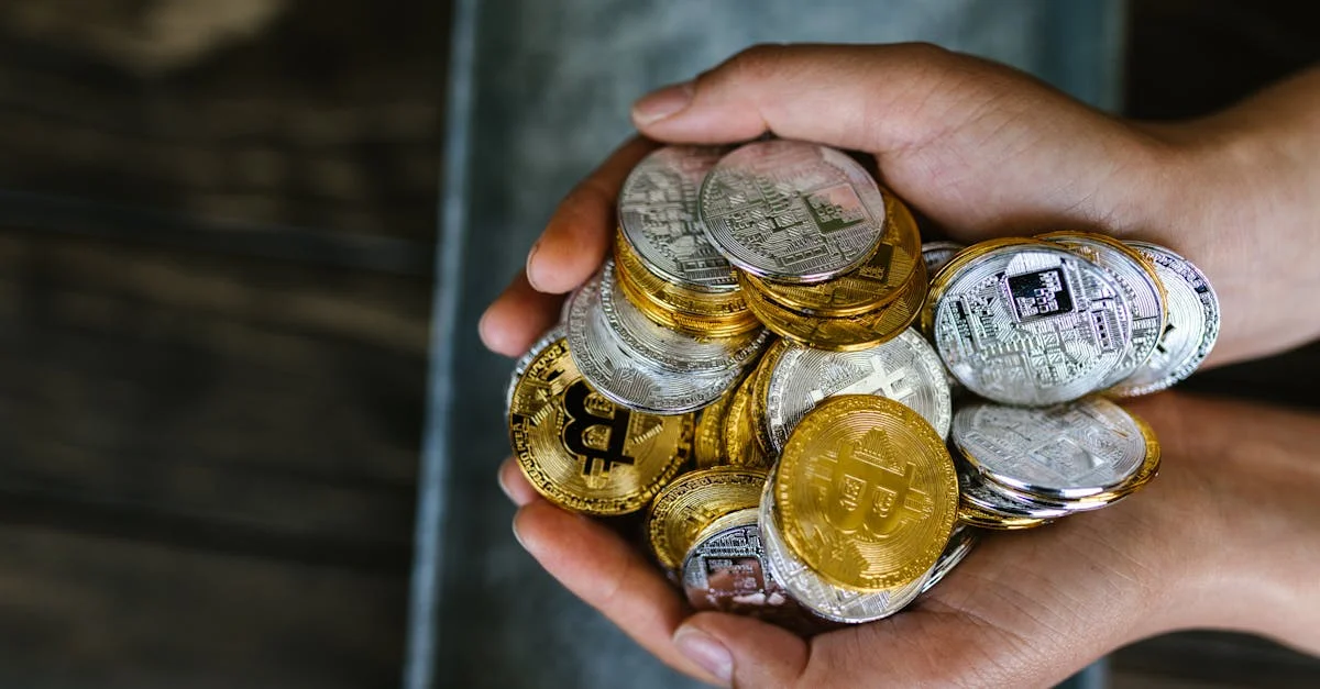 A close-up of hands holding various cryptocurrency coins, representing digital finance.