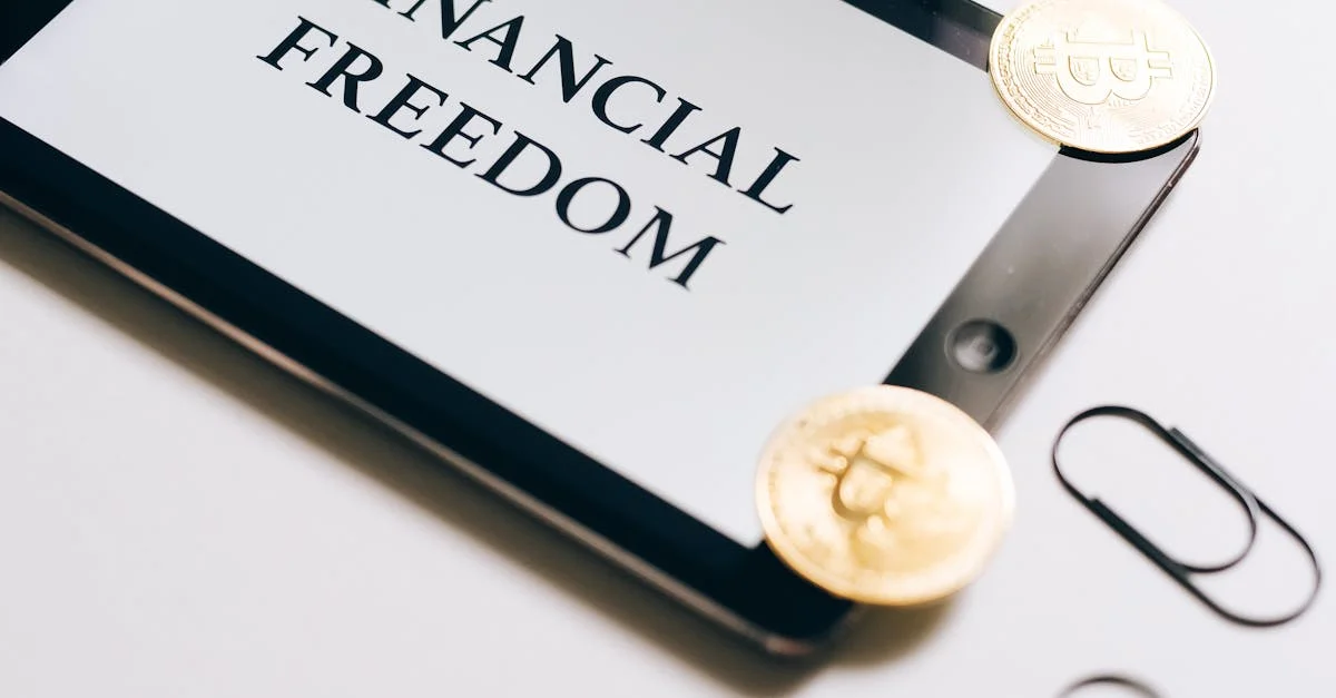 Coins are scattered around a digital tablet displaying 'Financial Freedom', symbolizing cryptocurrency wealth.