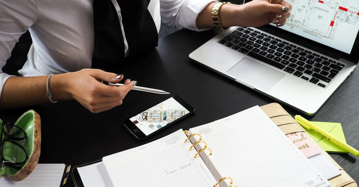 A business professional working on real estate project plans using multiple devices in an office setting.