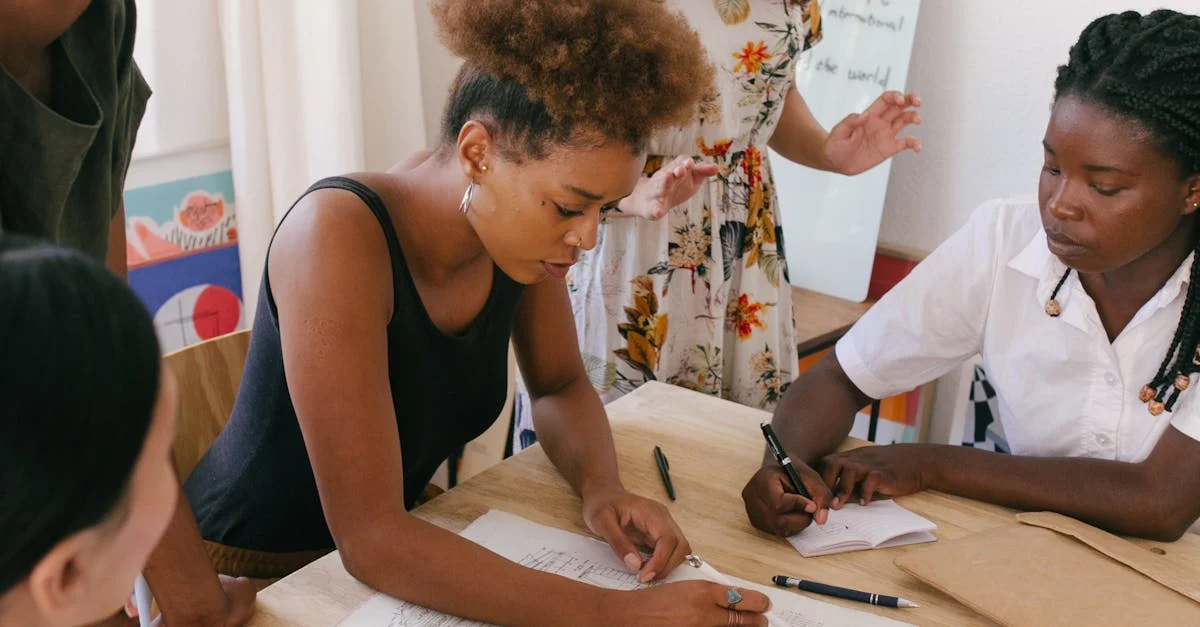 Group of women collaborating on a creative project in a modern office environment.