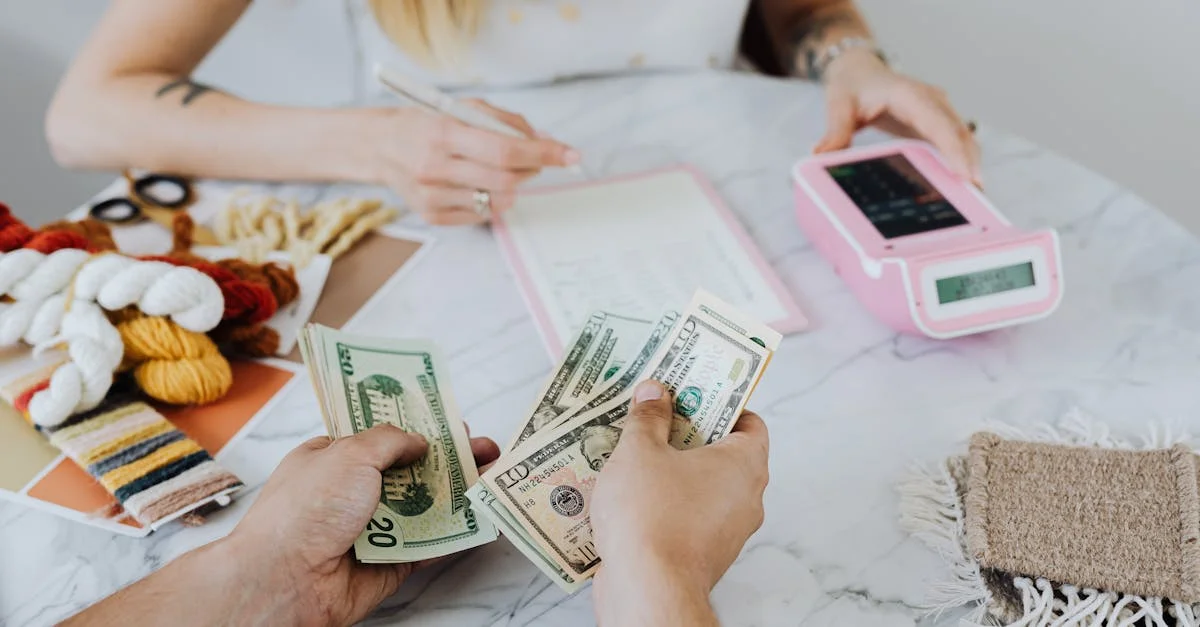 Two people handling cash and budgeting with a calculator and notebook at a table.